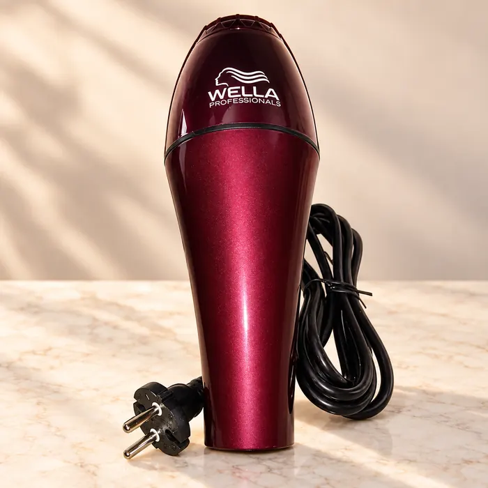 Burgundy hair dryer pad printed with the Wella Professionals logo